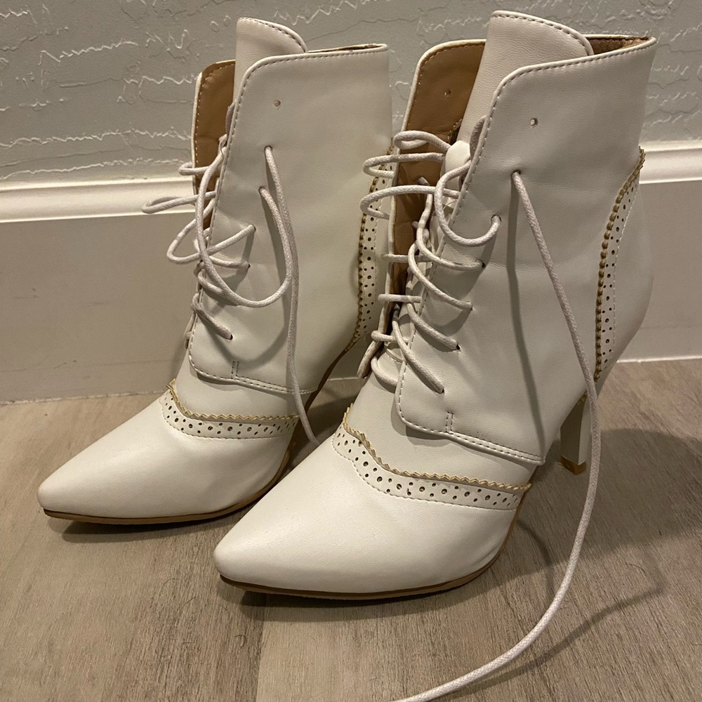 White leather wingtip boots